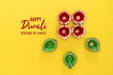 Happy Diwali - Clay Diya lamps lit during Dipavali, Hindu festival of lights celebration. Colorful traditional oil lamp diyaの写真素材