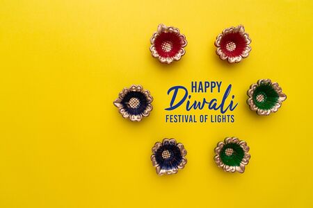 Happy Diwali - Clay Diya lamps lit during Diwali, Hindu festival of lights celebration. Colorful traditional oil lamp diyaの写真素材
