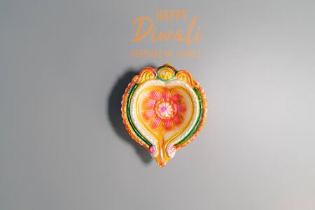Happy Diwali - Clay Diya lamps lit during Diwali, Hindu festival of lights celebration. Colorful traditional oil lamp diyaの写真素材
