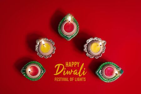 Happy Diwali - Clay Diya lamps lit during Diwali, Hindu festival of lights celebration. Colorful traditional oil lamp diyaの写真素材