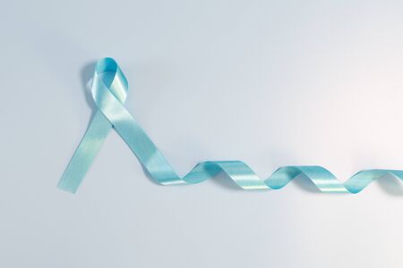 Prostate cancer awareness campaign concept, Men's health concept. light blue ribbon long tail on blue background. Symbol for support men who living with cancerの写真素材
