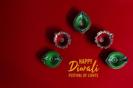 Happy Diwali - Clay Diya lamps lit during Diwali, Hindu festival of lights celebration. Colorful traditional oil lamp diyaの写真素材