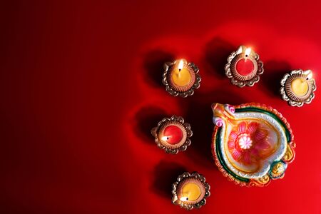 Happy Diwali - Clay Diya lamps lit during Diwali, Hindu festival of lights celebration. Colorful traditional oil lamp diyaの写真素材