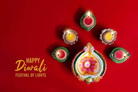 Happy Diwali - Clay Diya lamps lit during Diwali, Hindu festival of lights celebration. Colorful traditional oil lamp diyaの写真素材