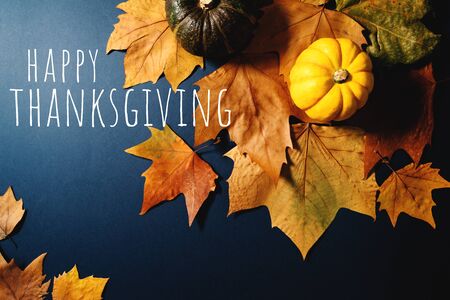 Happy Thanksgiving Day with maple leaves and pumpkin on blue backgroundの写真素材