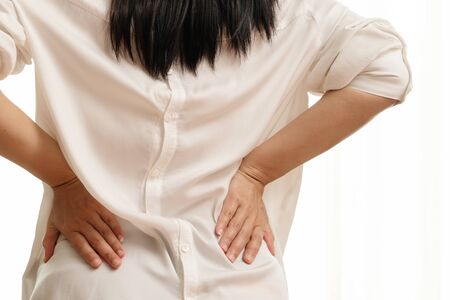 back pain at home. women suffer from backache. healthcare and medical conceptの写真素材