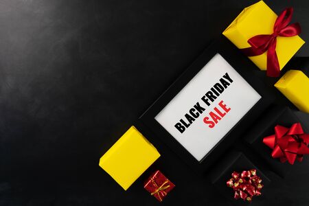 gift box with photo frame for Black Friday Sale concept on black backgroundの写真素材
