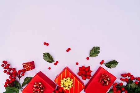 Christmas decoration. red gift box on purple background. Christmas, winter, new year concept. Flat lay, top view, copy spaceの写真素材