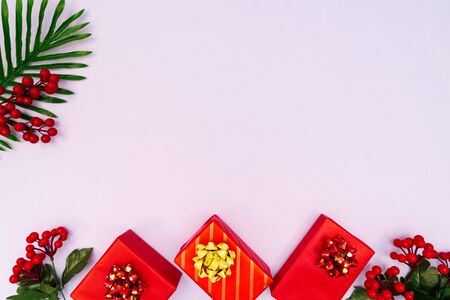 Christmas decoration. red gift box on purple background. Christmas, winter, new year concept. Flat lay, top view, copy spaceの写真素材