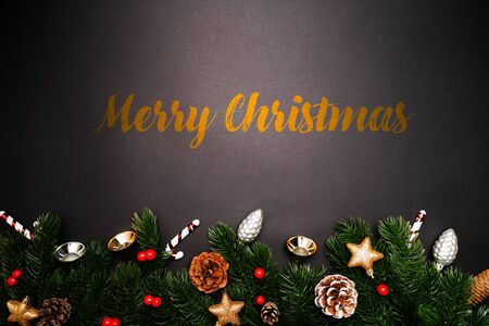 Christmas pine tree with xmas decoration on black backgroundの写真素材