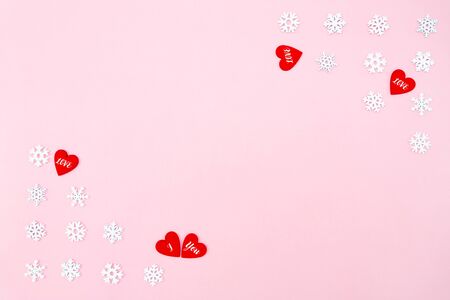 Valentine's Day background. red hearts and snowflakes on pink background. Valentines day concept. Flat lay, top view, copy spaceの写真素材