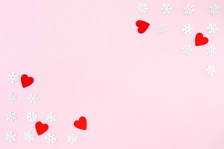 Valentine's Day background. red hearts and snowflakes on pink background. Valentines day concept. Flat lay, top view, copy spaceの写真素材