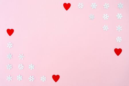 Valentine's Day background. red hearts and snowflakes on pink background. Valentines day concept. Flat lay, top view, copy spaceの写真素材