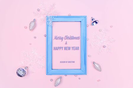 Christmas gold ball and snowflake with photo frame on pink backgroundの写真素材
