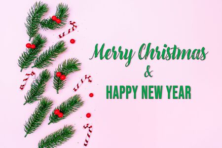 Christmas pine tree with xmas decoration on pink backgroundの写真素材