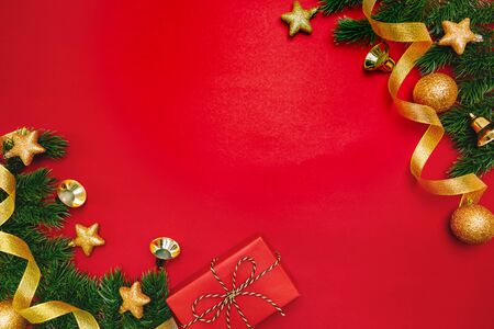 Christmas present and pine tree with xmas decoration on Red backgroundの写真素材