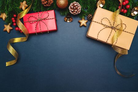 Christmas present and pine tree with xmas decoration on blue backgroundの写真素材