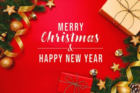 Christmas present and pine tree with xmas decoration on Red backgroundの写真素材