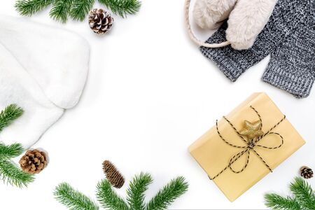 Christmas winter composition. Christmas gifts box with pine cones, fir branches on white background. Flat lay, top view, copy spaceの写真素材