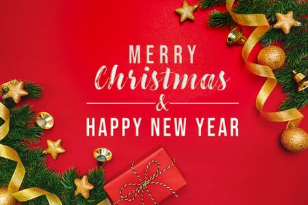 Christmas present and pine tree with xmas decoration on Red backgroundの写真素材