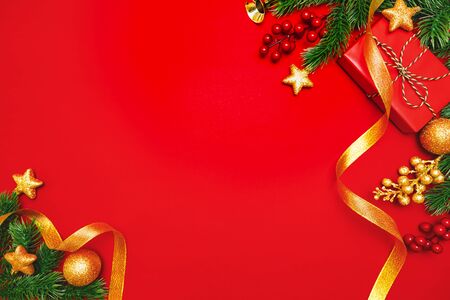 Christmas present and pine tree with xmas decoration on Red backgroundの写真素材
