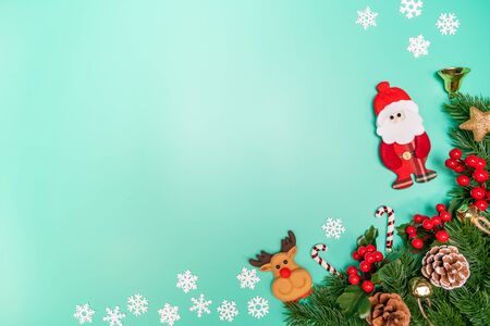 Christmas background concept. Top view of Christmas decoration, Santa Claus and reindeer with red gift box on green backgroundの写真素材