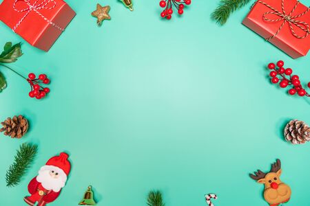 Christmas background concept. Top view of Christmas decoration, Santa Claus and reindeer with red gift box on green backgroundの写真素材