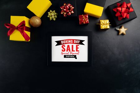 Boxing day sale with Christmas present and xmas decoration on black backgroundの写真素材