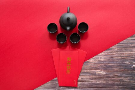 Chinese New Year offering red envelope and Chinese tea pot , Translation of text appear in image: Happy New Yearの写真素材