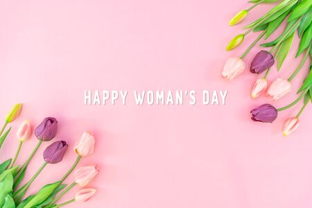 Woman Day composition. Tulip flowers on pink background Flat lay top view copy spaceの写真素材