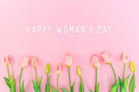 Woman Day composition. Tulip flowers on pink background Flat lay top view copy spaceの写真素材
