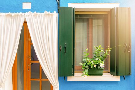 vintage wooden window and white curtain on blue cement backgroundの写真素材