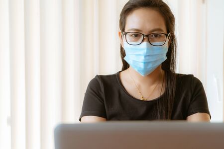 woman with face mask protection while working, Coronavirus, air pollution, allergy sick woman with medical maskの写真素材