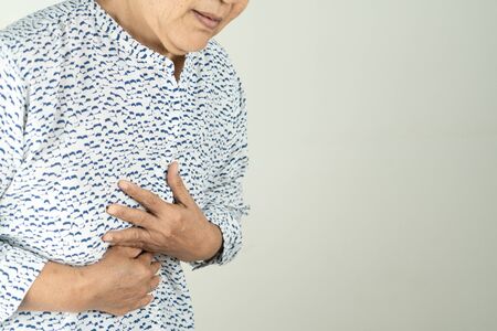 Senior woman Suffering From Acid Reflux Or Heartburn-Isolated On White Backgroundの写真素材
