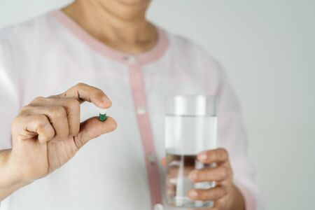 Medicine in senior woman hand and healthcare conceptの写真素材