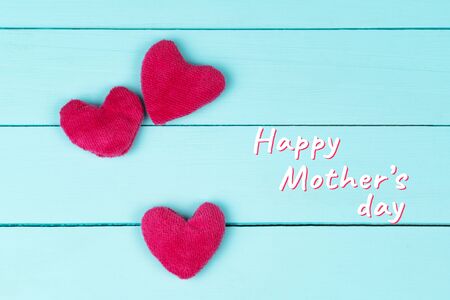 Mother's Day, pink hearts on blue wooden backgroundの写真素材