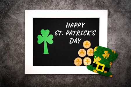 St Patricks day, festive leprechaun hat and green Shamrocks on photo frameの写真素材