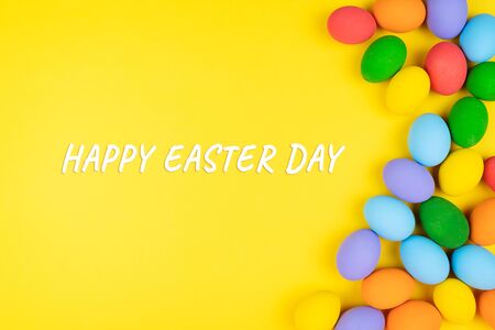 Easter day with decorated eggs on yellow backgroundの写真素材