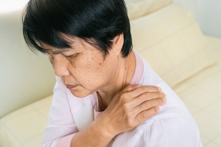 neck and shoulder pain of old woman, healthcare problem of senior conceptの写真素材