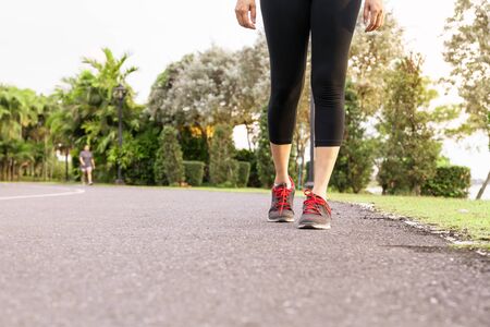 sport woman walking towards on the road side. Step conceptの写真素材