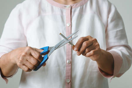 Quit smoking, no tobacco day, mother is cutting the cigaretteの写真素材