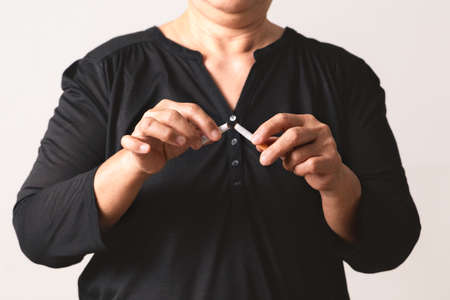 Quit smoking, no tobacco day, mother hands breaking the cigaretteの写真素材