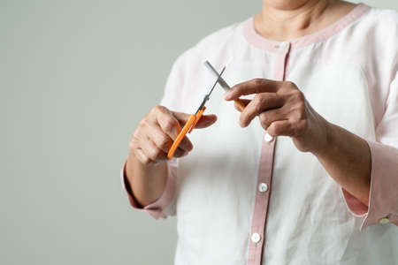 Quit smoking, no tobacco day, mother is cutting the cigaretteの写真素材