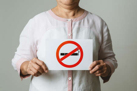 Quit smoking, no tobacco day, mother holding no smoking signの写真素材