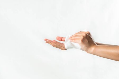 Woman cleaning her hands with white soft tissue paper. isolated on a white backgroundsの写真素材