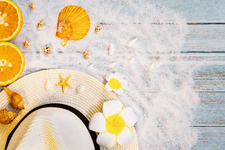 Beautiful summer holiday, Beach accessories, sunglasses, hat, oranges and shells on wooden backgroundsの写真素材