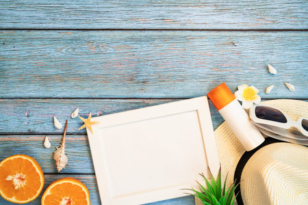 Beautiful summer holiday, Beach accessories, orange, sunglasses, hat and sunblock on wooden...