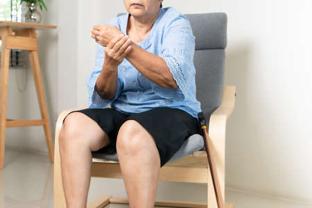 wrist hand pain of old woman, healthcare problem of senior conceptの写真素材