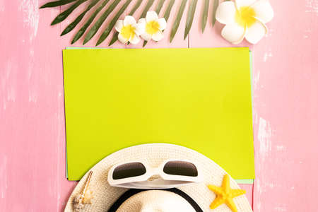 Beautiful summer holiday, Beach accessories, sea shells, hat, sunglasses and palm leave on paper for copy spaceの写真素材