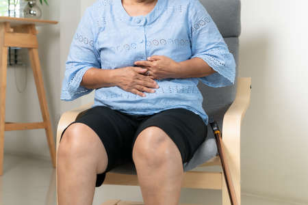 Senior woman Suffering From Acid Reflux Or Heartburn-Isolated On White Backgroundの写真素材